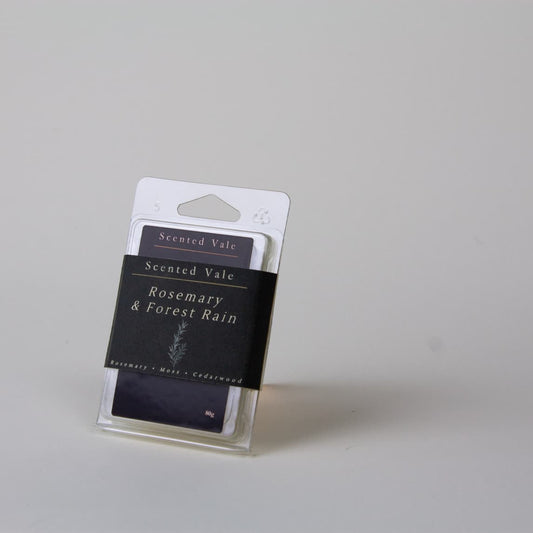 Scented Vale Rosemary & Forest Rain wax melts in a clear plastic clamshell package, photographed on a light grey background.