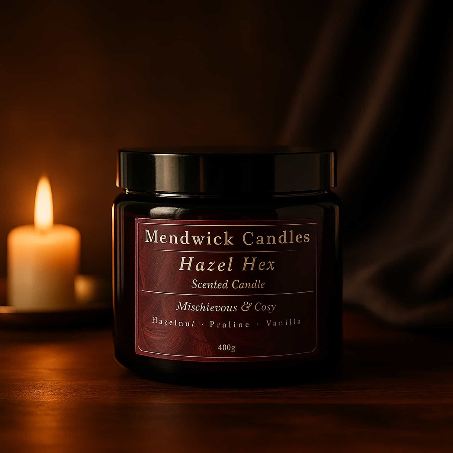 Mendwick Candles Hazel Hex candle in a black glass jar, styled against a warm, moody backdrop