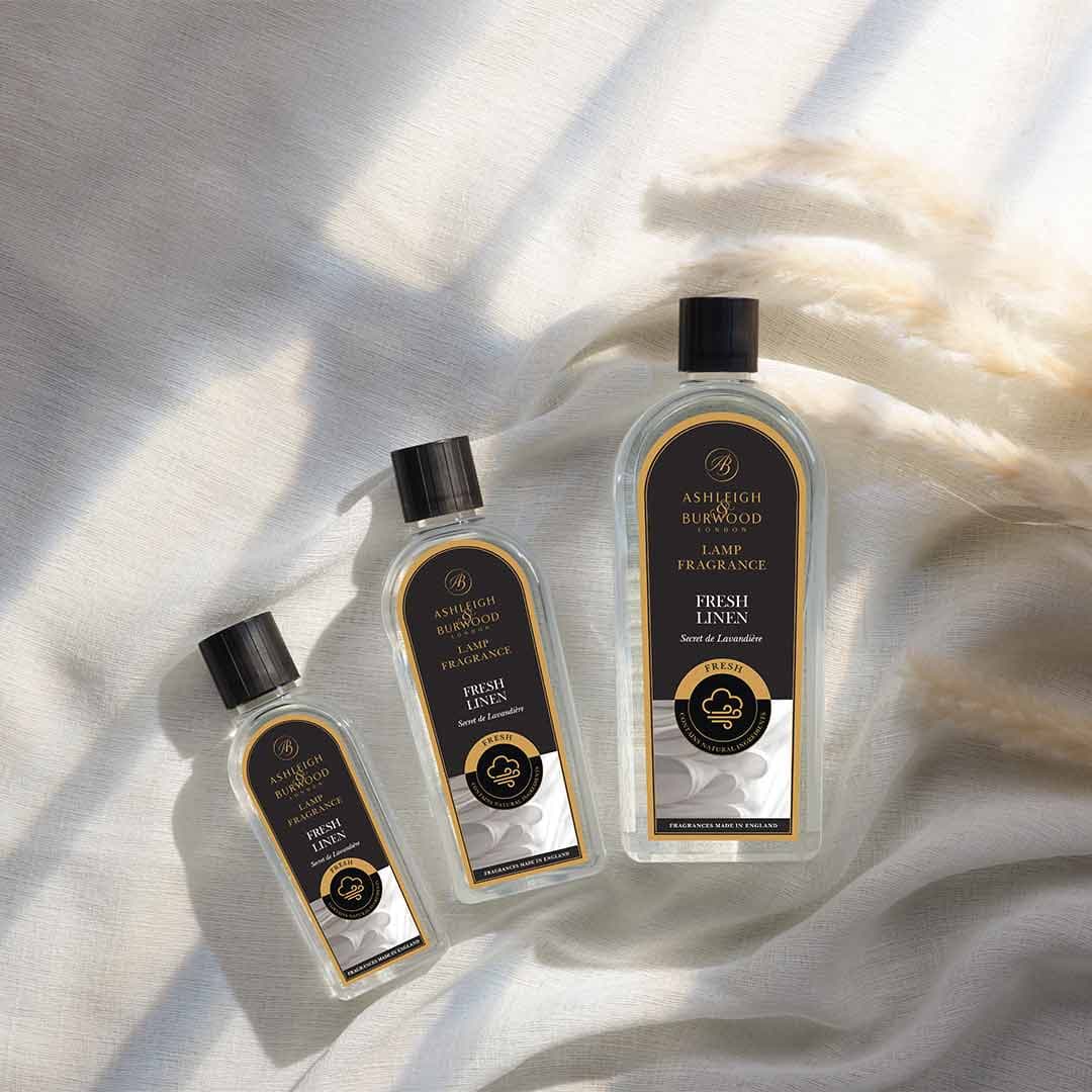 Ashleigh & Burwood Fresh Linen Lamp Fragrance  on a soft linen cloth with sunlight and pampas grasss