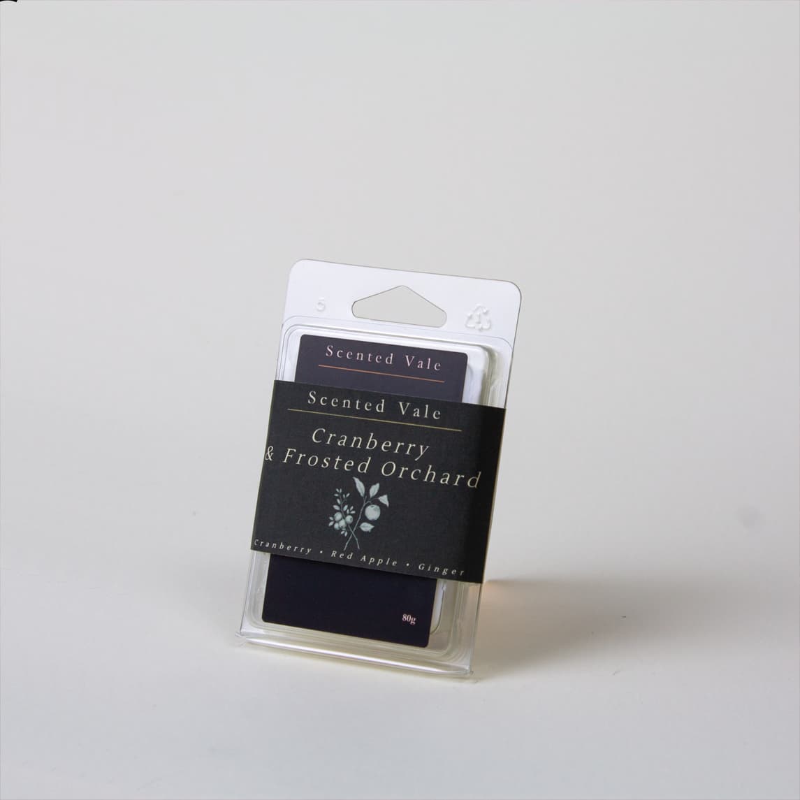 Scented Vale Cranberry & Frosted Orchard wax melts in a clear plastic clamshell package with a white hanger card and black label, photographed on a light gray background.