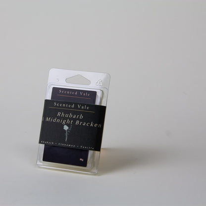 Scented Vale Rhubarb Midnight Bracken wax melts in a clear plastic clamshell package with a dark paper band label, photographed on a plain light grey background.