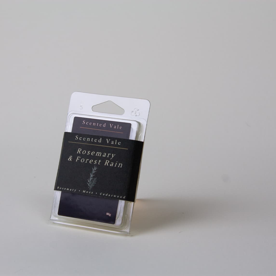Scented Vale Rosemary & Forest Rain wax melts in a clear plastic clamshell package, photographed on a light grey background.