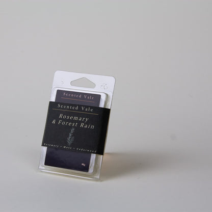 Scented Vale Rosemary & Forest Rain wax melts in a clear plastic clamshell package, photographed on a light grey background.